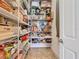 Well-organized walk-in pantry with ample shelving for all your storage needs at 759 Villa Park Rd, Poinciana, FL 34759