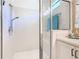 Walk-in shower with glass door, white tile and a shower head with a handheld wand at 759 Villa Park Rd, Poinciana, FL 34759