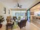 Bright sunroom with comfortable seating, ceiling fan, and a view of the outdoors at 759 Villa Park Rd, Poinciana, FL 34759