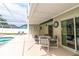 Backyard outdoor dining table and chairs with direct access to a screened-in pool at 7794 Indian Ridge S Trl, Kissimmee, FL 34747