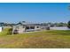 Backyard view showcasing the screened-in pool, fenced perimeter, and well-maintained lawn at 7794 Indian Ridge S Trl, Kissimmee, FL 34747