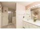 Bright bathroom with a shower and vanity with ample lighting at 7794 Indian Ridge S Trl, Kissimmee, FL 34747