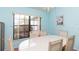 Bright dining room with ample natural light, seating for six, and blue walls at 7794 Indian Ridge S Trl, Kissimmee, FL 34747