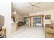 Bright living room with tile floors, ceiling fan, and sliding glass doors overlooking the pool at 7794 Indian Ridge S Trl, Kissimmee, FL 34747