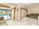 Cozy living area featuring tile flooring, comfortable seating, and sliding doors to the screened pool at 7794 Indian Ridge S Trl, Kissimmee, FL 34747