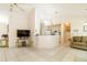 Spacious living room with tile flooring, a neutral color palette, and a breakfast bar open to the kitchen at 7794 Indian Ridge S Trl, Kissimmee, FL 34747