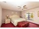 Cozy main bedroom with a ceiling fan, a large bed, and ample natural light at 7794 Indian Ridge S Trl, Kissimmee, FL 34747