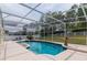 Relaxing screened-in pool and spa area with outdoor lounge chairs and a lush green lawn at 7794 Indian Ridge S Trl, Kissimmee, FL 34747