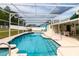 Inviting screened-in pool with ample deck space and a classic fountain feature at 7794 Indian Ridge S Trl, Kissimmee, FL 34747