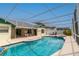 Lovely screened-in pool area with patio furniture and view of the home's exterior at 7794 Indian Ridge S Trl, Kissimmee, FL 34747