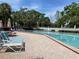 Community pool area with lounge chairs, perfect for relaxing and enjoying the outdoors at 7794 Indian Ridge S Trl, Kissimmee, FL 34747