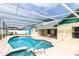 A refreshing in-ground pool with screened enclosure, patio table, and well-maintained outdoor space at 7794 Indian Ridge S Trl, Kissimmee, FL 34747