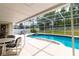 A patio is attached to an enclosed pool and hot tub at 7794 Indian Ridge S Trl, Kissimmee, FL 34747