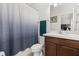 Bathroom features a vanity with solid surface countertop, cabinet and framed mirror at 840 Luarca Ln, Oviedo, FL 32765