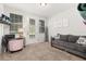 Well-lit room with carpeting and a door to the outside, as well as a TV, couch and a pink chair at 840 Luarca Ln, Oviedo, FL 32765