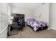 Comfortable bedroom with dark wooden desk, purple butterfly bedding and a ceiling light at 840 Luarca Ln, Oviedo, FL 32765