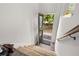 Inviting entryway featuring a wood-look floor, carpeted stairs, and an open door with an 