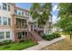 Charming multi-story condo with brick accents, a covered porch, and lush landscaping at 840 Luarca Ln, Oviedo, FL 32765