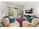 Comfortable living room with plush seating, large screen TV, and access to a balcony at 840 Luarca Ln, Oviedo, FL 32765
