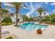 A gorgeous community pool surrounded by tropical palm trees, lounge chairs, and well-maintained landscaping at 840 Luarca Ln, Oviedo, FL 32765