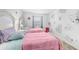Bright bedroom with two beds, whimsical wall decor, and cozy furnishings at 8968 Amelia Downs Trl, Kissimmee, FL 34747