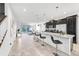 Bright, modern kitchen with dark wood cabinets, stainless appliances, and a large island with bar seating at 8968 Amelia Downs Trl, Kissimmee, FL 34747