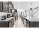 Modern kitchen with sleek cabinets, stainless steel appliances, and an open view to the dining area at 8968 Amelia Downs Trl, Kissimmee, FL 34747