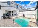 Private pool area with screened enclosure, lounge seating, and ample space for relaxation at 8968 Amelia Downs Trl, Kissimmee, FL 34747