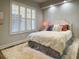 Cozy bedroom with a plush rug, shuttered windows, and a comfortable bed with decorative pillows at 910 Spring Park St # 103, Celebration, FL 34747