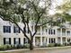 Building exterior with balconies, shutters, and landscaping, showcasing the architectural design at 910 Spring Park St # 103, Celebration, FL 34747