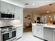 Open kitchen featuring stainless steel appliances, white countertops, and views of living area for entertaining at 910 Spring Park St # 103, Celebration, FL 34747