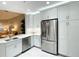 Bright kitchen showcasing white cabinets, stainless steel appliances, and an open design for easy entertaining at 910 Spring Park St # 103, Celebration, FL 34747