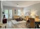 Bright living room boasts wood floors, a comfortable seating area, and natural light from the French doors at 910 Spring Park St # 103, Celebration, FL 34747