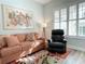 Comfortable living room with a sofa, recliner, and a large window with shutters for natural light at 910 Spring Park St # 103, Celebration, FL 34747
