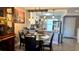 Open-concept dining area, adjacent to the kitchen, with pendant lighting and seating at 13840 Timberbrooke Dr # 103, Orlando, FL 32824