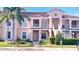 Inviting two-story condo with lush landscaping, mature palm trees, and reserved parking at 13840 Timberbrooke Dr # 103, Orlando, FL 32824