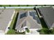 Aerial view of a house featuring solar panels and a well-maintained lawn at 1061 Citrus Landings Blvd, Davenport, FL 33837