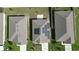 Aerial view of home's roof with solar panels for energy efficiency and neighborhood at 1061 Citrus Landings Blvd, Davenport, FL 33837