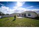 View of backyard featuring a small patio and lawn, perfect for outdoor enjoyment at 1061 Citrus Landings Blvd, Davenport, FL 33837