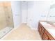 Bright bathroom featuring a glass shower, tile floors, and a vanity with dual sinks at 1061 Citrus Landings Blvd, Davenport, FL 33837