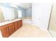 Bright bathroom featuring double vanity, soaking tub, and glass-enclosed shower at 1061 Citrus Landings Blvd, Davenport, FL 33837