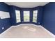 This bedroom features navy blue walls and a beautiful bay window offering lots of natural light at 1061 Citrus Landings Blvd, Davenport, FL 33837