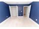 The spacious bedroom has navy blue walls and an open closet for ample storage space at 1061 Citrus Landings Blvd, Davenport, FL 33837