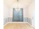 Bright dining room featuring decorative wall panels, tile floors, and a modern chandelier at 1061 Citrus Landings Blvd, Davenport, FL 33837
