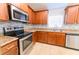 Well-appointed kitchen featuring stainless steel appliances, granite countertops, and custom cabinetry at 1061 Citrus Landings Blvd, Davenport, FL 33837