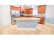 Bright and spacious kitchen featuring stainless steel appliances, granite countertops, and an island at 1061 Citrus Landings Blvd, Davenport, FL 33837