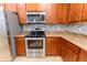 This kitchen features stainless steel appliances, a tile backsplash, and granite countertops at 1061 Citrus Landings Blvd, Davenport, FL 33837