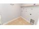 Practical laundry room setup with tile flooring and shelving unit at 1061 Citrus Landings Blvd, Davenport, FL 33837