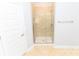 The bathroom features a glass enclosed tile shower with a chrome shower head and towel bar at 1061 Citrus Landings Blvd, Davenport, FL 33837