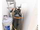Close-up view of water filtration and softener system in the utility closet at 1061 Citrus Landings Blvd, Davenport, FL 33837